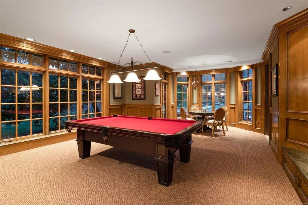 8 Lochinvar Drive Home in Saint Louis, Missouri. This stunning custom built home features a cascading waterfall, spacious living areas, and a finished lower level with every amenity. It is perfect for everyday living and entertaining.