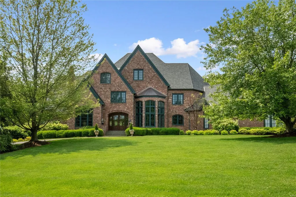 8 Lochinvar Drive Home in Saint Louis, Missouri. This stunning custom built home features a cascading waterfall, spacious living areas, and a finished lower level with every amenity. It is perfect for everyday living and entertaining.
