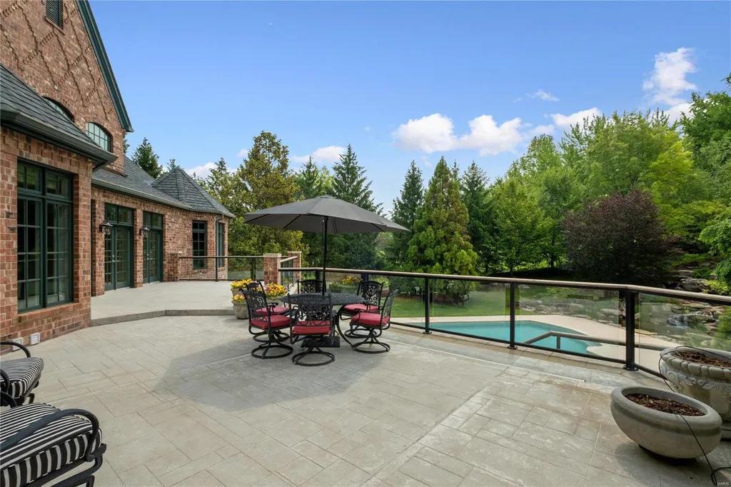 8 Lochinvar Drive Home in Saint Louis, Missouri. This stunning custom built home features a cascading waterfall, spacious living areas, and a finished lower level with every amenity. It is perfect for everyday living and entertaining.