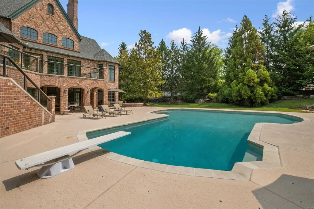 8 Lochinvar Drive Home in Saint Louis, Missouri. This stunning custom built home features a cascading waterfall, spacious living areas, and a finished lower level with every amenity. It is perfect for everyday living and entertaining.