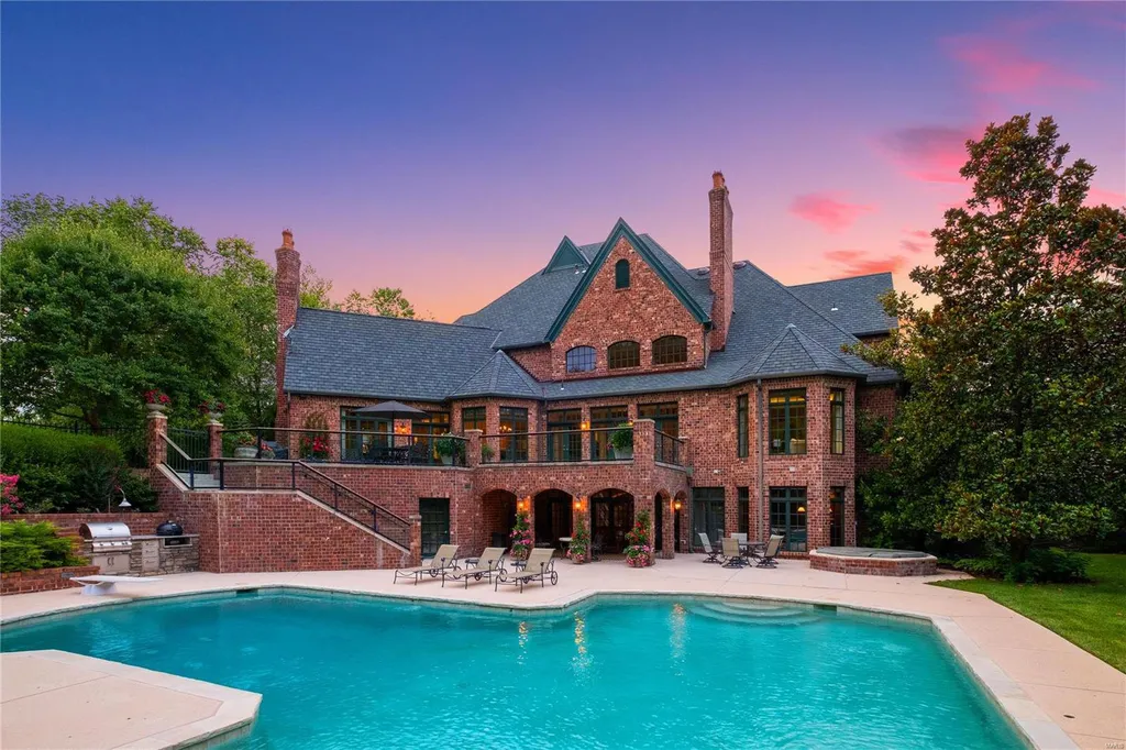 8 Lochinvar Drive Home in Saint Louis, Missouri. This stunning custom built home features a cascading waterfall, spacious living areas, and a finished lower level with every amenity. It is perfect for everyday living and entertaining.