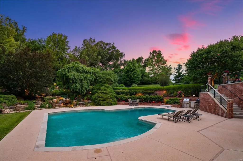 8 Lochinvar Drive Home in Saint Louis, Missouri. This stunning custom built home features a cascading waterfall, spacious living areas, and a finished lower level with every amenity. It is perfect for everyday living and entertaining.