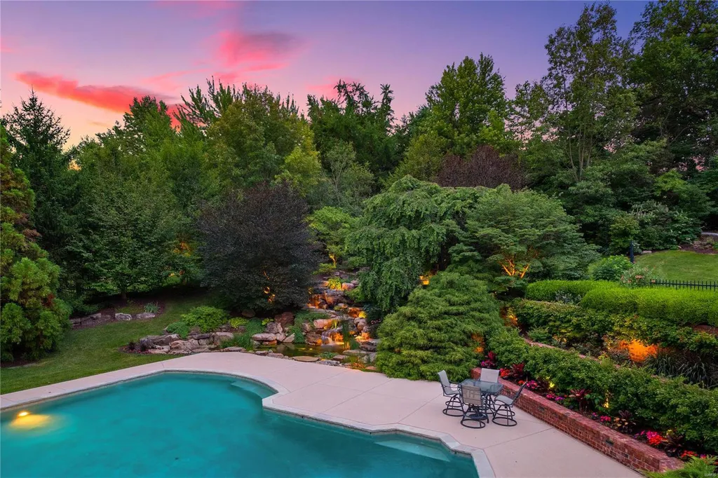8 Lochinvar Drive Home in Saint Louis, Missouri. This stunning custom built home features a cascading waterfall, spacious living areas, and a finished lower level with every amenity. It is perfect for everyday living and entertaining.