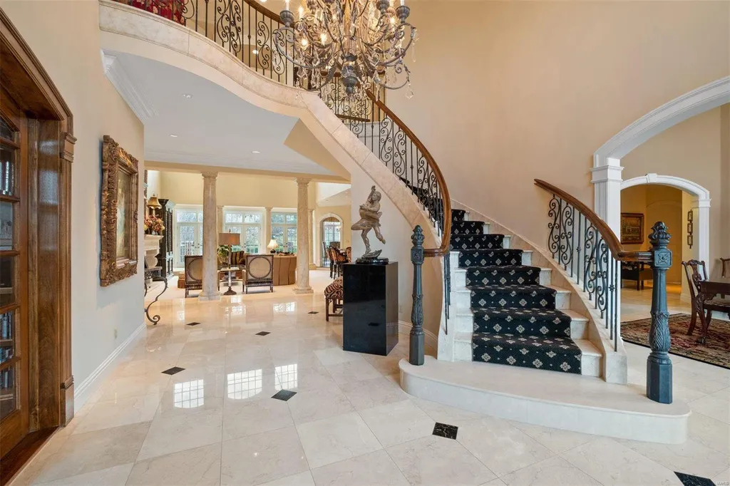 8 Lochinvar Drive Home in Saint Louis, Missouri. This stunning custom built home features a cascading waterfall, spacious living areas, and a finished lower level with every amenity. It is perfect for everyday living and entertaining.