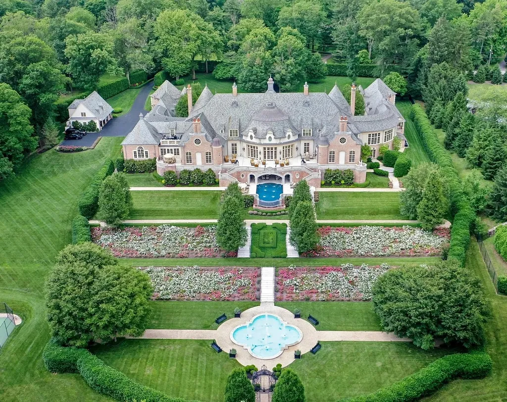 841 Merion Square Road Home in Gladwyne, Pennsylvania. This exceptional French Chateau estate, a rare gem designed by renowned architect F.L. Bissinger, awaits its new owner. Nestled on over 7 private and serene acres in prestigious Gladwyne, this regal compound is surrounded by meticulously manicured gardens, lush grounds, majestic fountains, and towering trees, offering an ambiance of unparalleled grandeur.