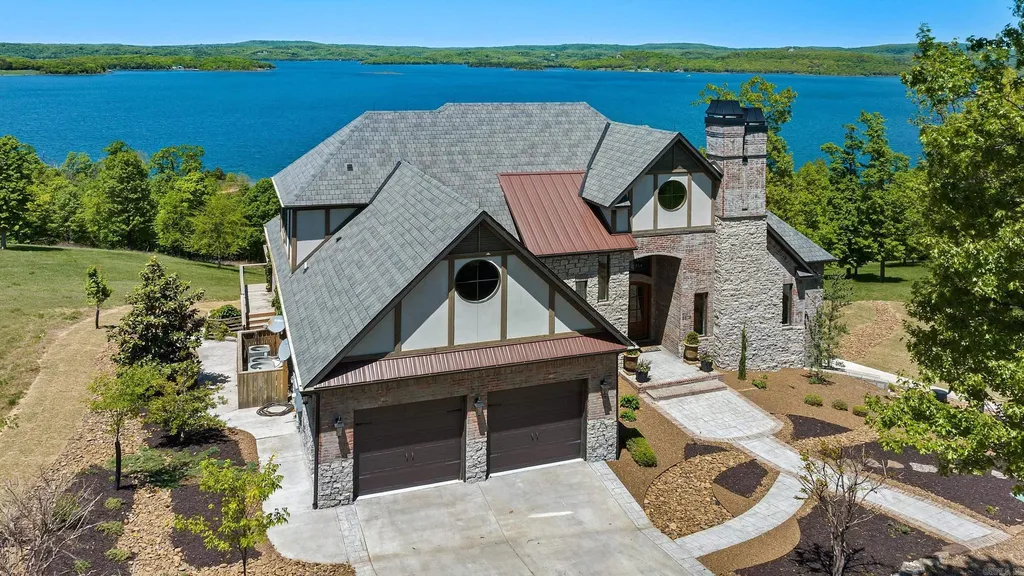 Lakefront Luxury Living: Exquisite Custom Home with Beaver Lake Views in Arkansas Listed at $3,850,000 7 8919 Castleberry Way Home in Rogers, Arkansas. Discover the epitome of luxury living on a sought-after .97-acre lot with breathtaking Beaver Lake views. This custom-built home is a masterpiece, boasting meticulously landscaped grounds and thoughtfully designed spaces for both formal and casual living.