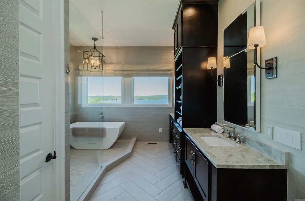 Lakefront Luxury Living: Exquisite Custom Home with Beaver Lake Views in Arkansas Listed at $3,850,000 29 8919 Castleberry Way Home in Rogers, Arkansas. Discover the epitome of luxury living on a sought-after .97-acre lot with breathtaking Beaver Lake views. This custom-built home is a masterpiece, boasting meticulously landscaped grounds and thoughtfully designed spaces for both formal and casual living.