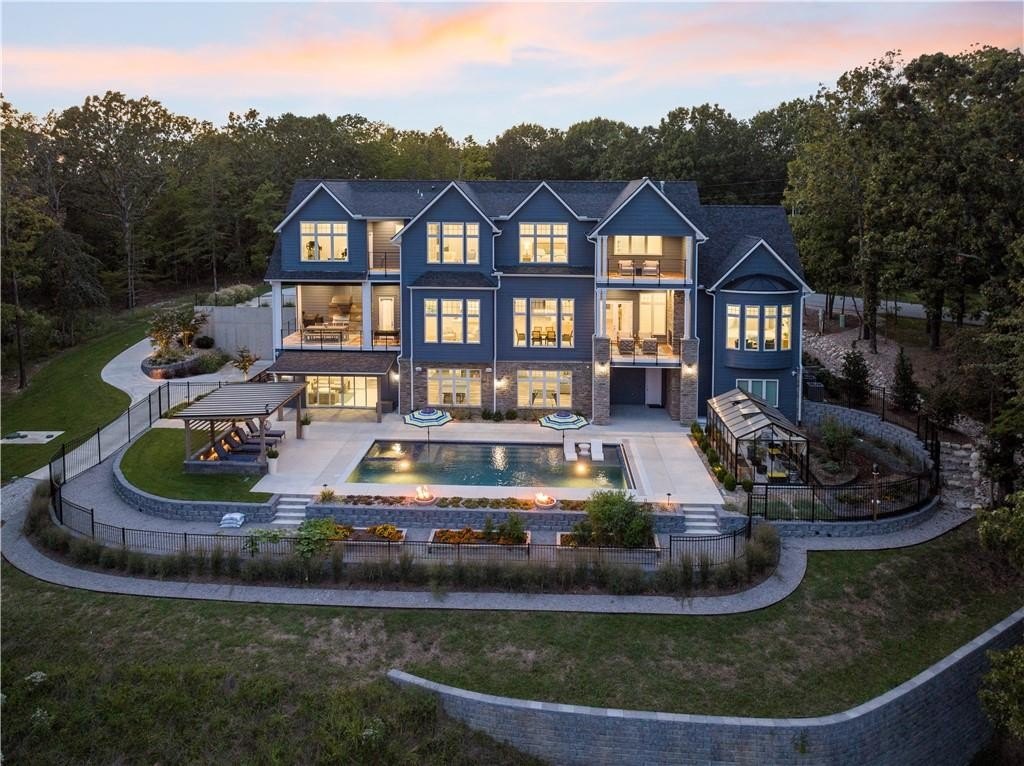 9966 Old Campbell Road Home in Rogers, Arkansas. Prepare to be captivated by this extraordinary 5-bedroom, 6.5-bathroom, 8,321 sqft estate, nestled on 6 acres in Rogers. It includes ownership of TWO slips in a co-owned boat dock, granting exclusive access to pristine Beaver Lake.