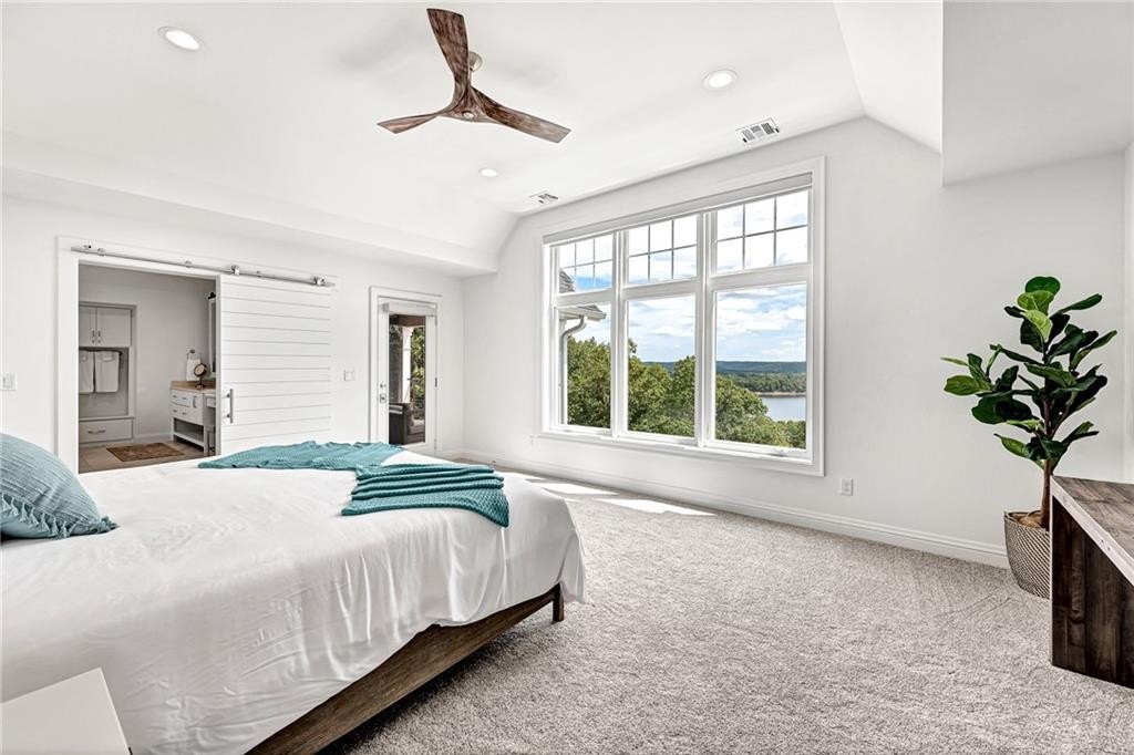 9966 Old Campbell Road Home in Rogers, Arkansas. Prepare to be captivated by this extraordinary 5-bedroom, 6.5-bathroom, 8,321 sqft estate, nestled on 6 acres in Rogers. It includes ownership of TWO slips in a co-owned boat dock, granting exclusive access to pristine Beaver Lake.