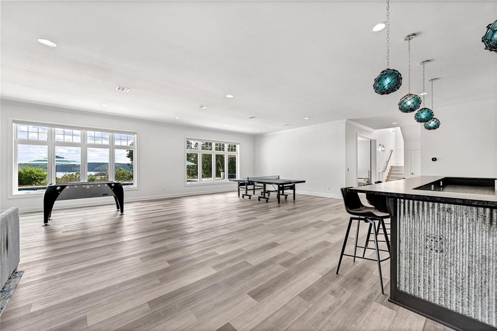 9966 Old Campbell Road Home in Rogers, Arkansas. Prepare to be captivated by this extraordinary 5-bedroom, 6.5-bathroom, 8,321 sqft estate, nestled on 6 acres in Rogers. It includes ownership of TWO slips in a co-owned boat dock, granting exclusive access to pristine Beaver Lake.