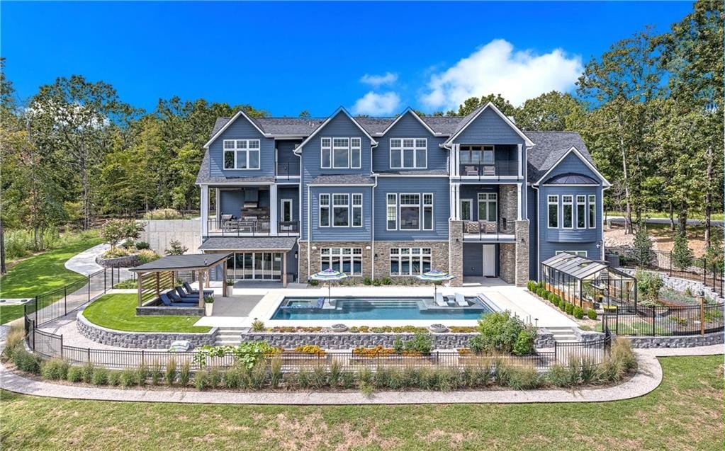 9966 Old Campbell Road Home in Rogers, Arkansas. Prepare to be captivated by this extraordinary 5-bedroom, 6.5-bathroom, 8,321 sqft estate, nestled on 6 acres in Rogers. It includes ownership of TWO slips in a co-owned boat dock, granting exclusive access to pristine Beaver Lake.