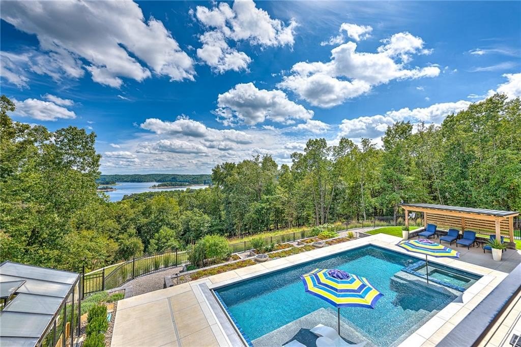9966 Old Campbell Road Home in Rogers, Arkansas. Prepare to be captivated by this extraordinary 5-bedroom, 6.5-bathroom, 8,321 sqft estate, nestled on 6 acres in Rogers. It includes ownership of TWO slips in a co-owned boat dock, granting exclusive access to pristine Beaver Lake.