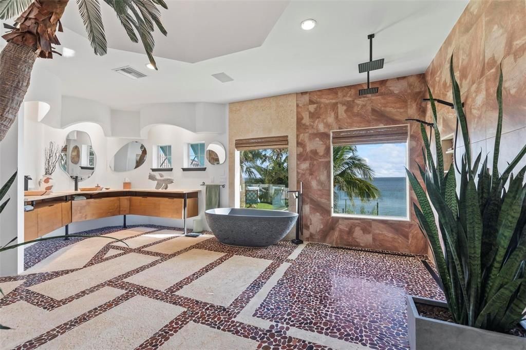 Discover the epitome of luxury living at 2 River Falls Drive, Cocoa Beach, Florida. This 5-bedroom, 6-bathroom custom estate, fully remodeled in 2022, offers 150 feet of pristine river frontage and unobstructed views.