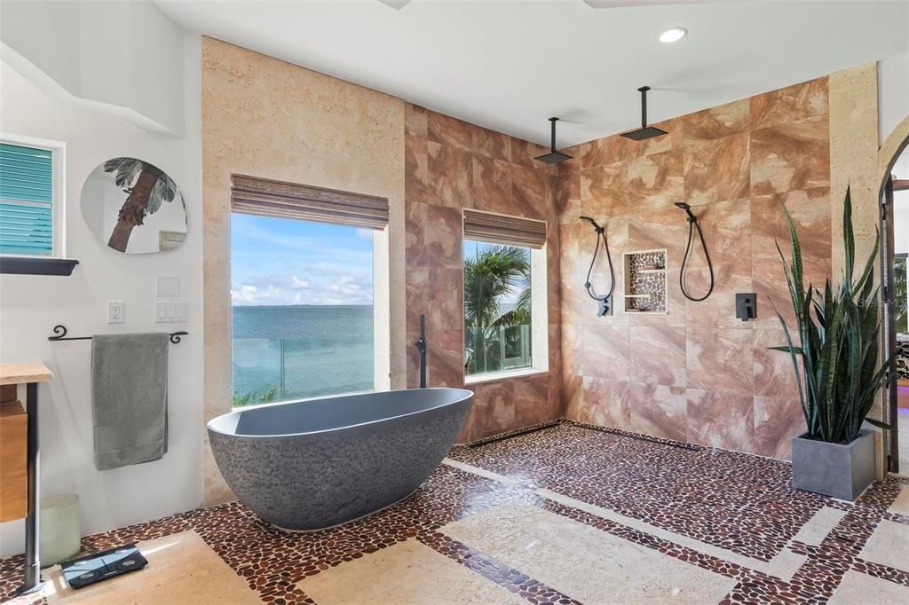 Discover the epitome of luxury living at 2 River Falls Drive, Cocoa Beach, Florida. This 5-bedroom, 6-bathroom custom estate, fully remodeled in 2022, offers 150 feet of pristine river frontage and unobstructed views.