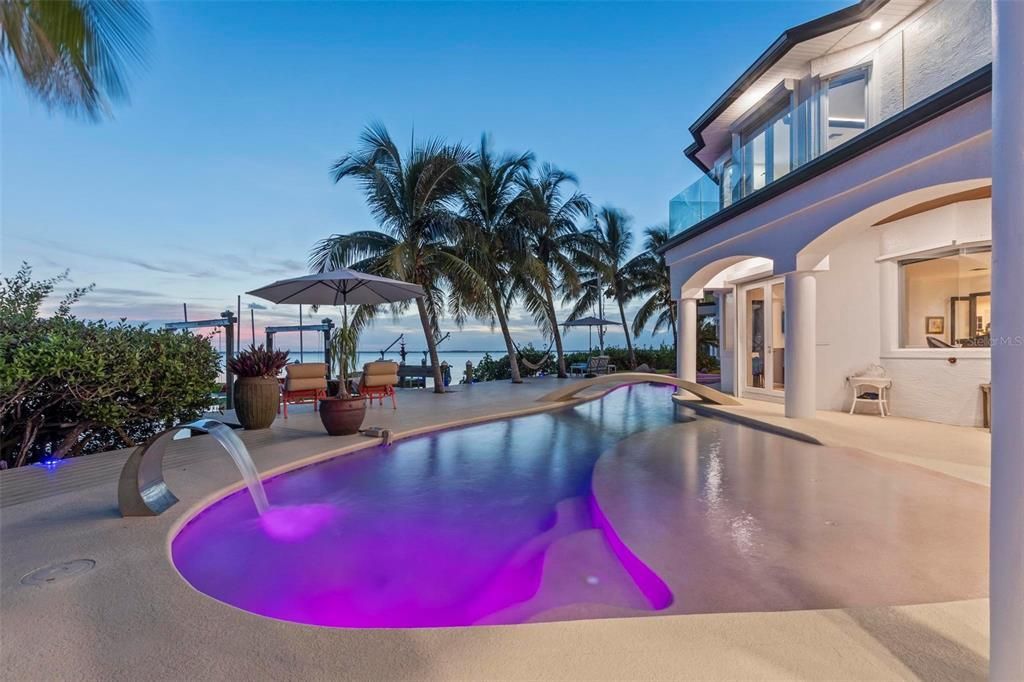 Discover the epitome of luxury living at 2 River Falls Drive, Cocoa Beach, Florida. This 5-bedroom, 6-bathroom custom estate, fully remodeled in 2022, offers 150 feet of pristine river frontage and unobstructed views.