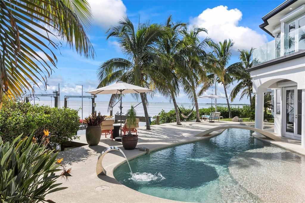 Discover the epitome of luxury living at 2 River Falls Drive, Cocoa Beach, Florida. This 5-bedroom, 6-bathroom custom estate, fully remodeled in 2022, offers 150 feet of pristine river frontage and unobstructed views.