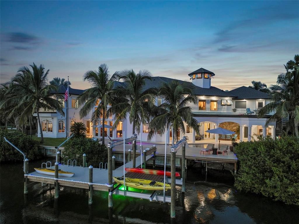 Discover the epitome of luxury living at 2 River Falls Drive, Cocoa Beach, Florida. This 5-bedroom, 6-bathroom custom estate, fully remodeled in 2022, offers 150 feet of pristine river frontage and unobstructed views.
