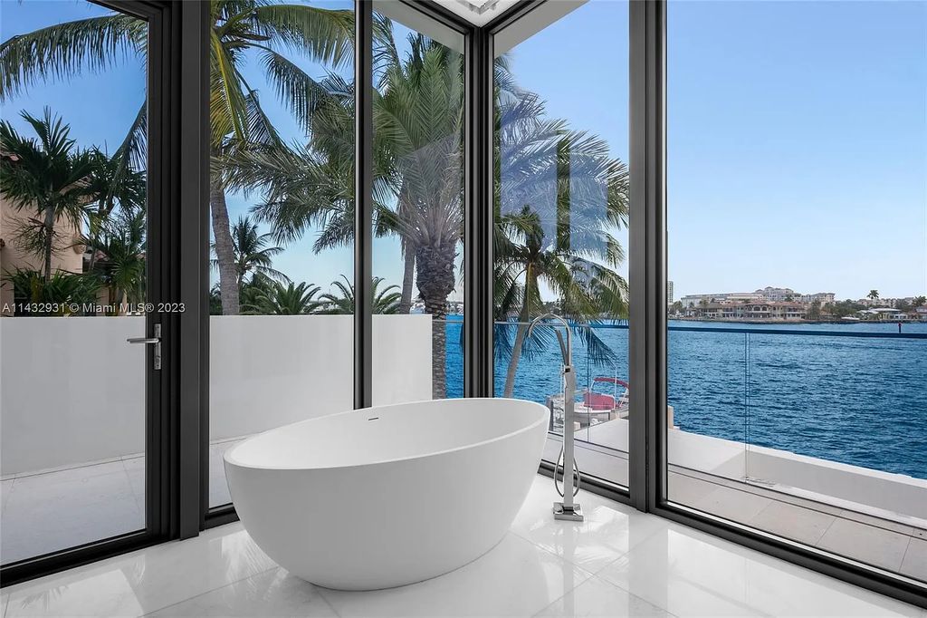 Luxury awaits in this 2021-built, 6-bed, 9-bath modern masterpiece in Fort Lauderdale's Harbor Beach gated community. Designed by Randall Stofft and crafted by Sarkela Corp, this 9,451 sq ft home features 120 ft of Intracoastal frontage, a lap pool, and outdoor kitchen.