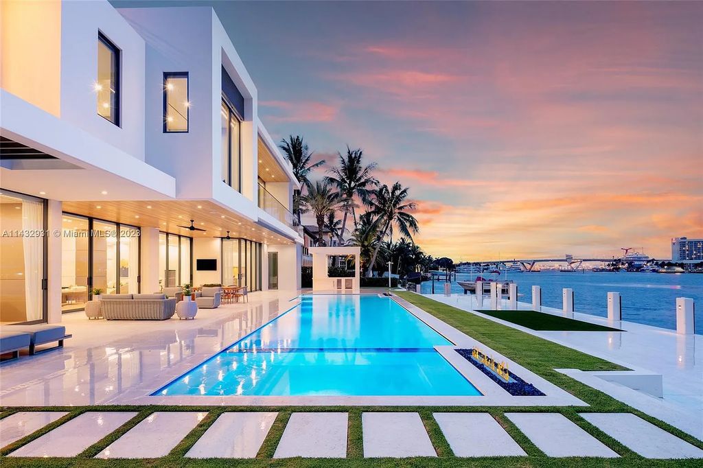 Luxury awaits in this 2021-built, 6-bed, 9-bath modern masterpiece in Fort Lauderdale's Harbor Beach gated community. Designed by Randall Stofft and crafted by Sarkela Corp, this 9,451 sq ft home features 120 ft of Intracoastal frontage, a lap pool, and outdoor kitchen.