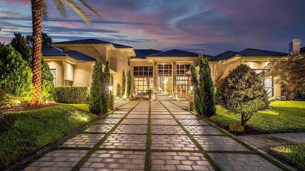 Welcome to 17999 Lake Estates Dr, Boca Raton, Florida, a Frank Lloyd Wright-inspired masterpiece that seamlessly marries modern luxury with natural beauty and advanced technology. This extraordinary estate greets you with dramatic two-story architecture and a 23-foot glass wall offering stunning views of the infinity pool, the sprawling lake, and the golf course.