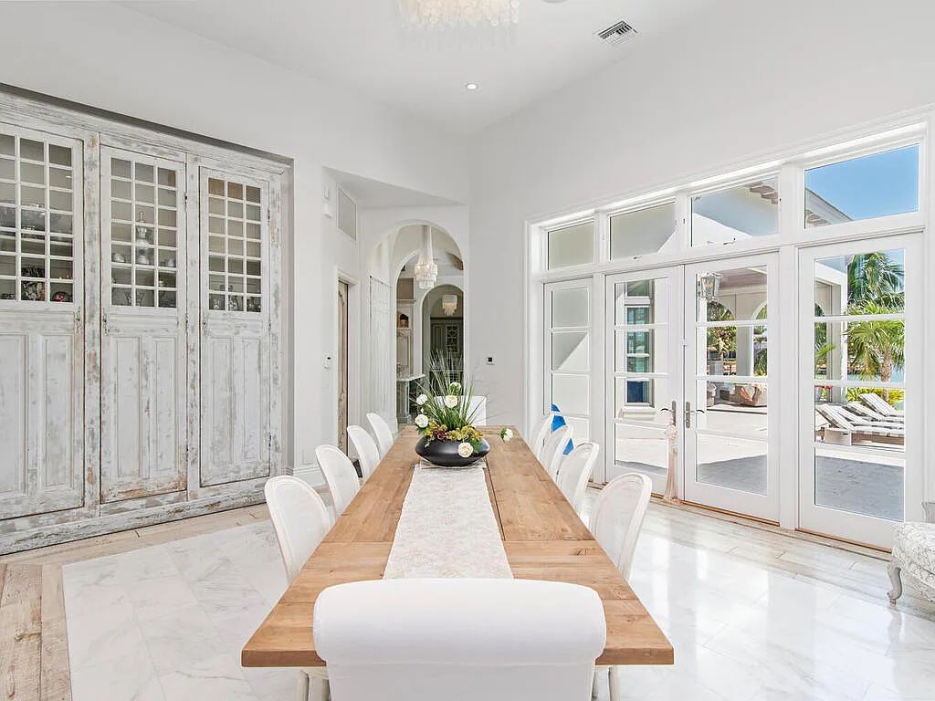 Discover your dream home at 1340 Caxambas Ct, Marco Island, Florida! This 5-bed, 5-bath luxury residence with a theater room boasts 5,007 sq ft of impeccable craftsmanship, situated on 0.59 acres with 248 ft of water frontage and a newer seawall, ensuring endless views and quick access to Caxambas Pass.