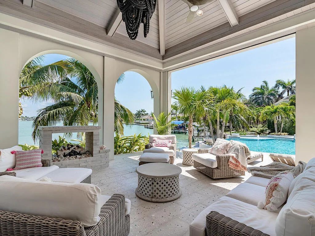 Discover your dream home at 1340 Caxambas Ct, Marco Island, Florida! This 5-bed, 5-bath luxury residence with a theater room boasts 5,007 sq ft of impeccable craftsmanship, situated on 0.59 acres with 248 ft of water frontage and a newer seawall, ensuring endless views and quick access to Caxambas Pass.