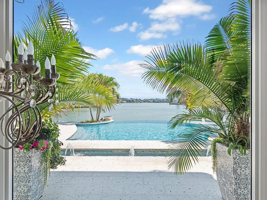 Discover your dream home at 1340 Caxambas Ct, Marco Island, Florida! This 5-bed, 5-bath luxury residence with a theater room boasts 5,007 sq ft of impeccable craftsmanship, situated on 0.59 acres with 248 ft of water frontage and a newer seawall, ensuring endless views and quick access to Caxambas Pass.