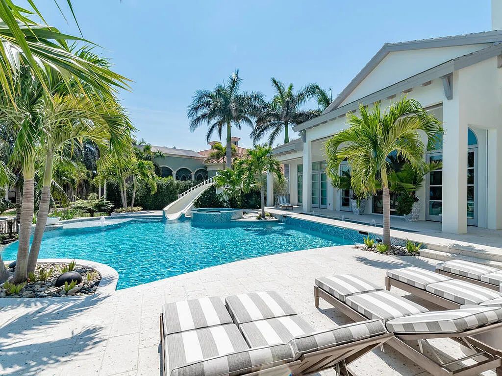 Discover your dream home at 1340 Caxambas Ct, Marco Island, Florida! This 5-bed, 5-bath luxury residence with a theater room boasts 5,007 sq ft of impeccable craftsmanship, situated on 0.59 acres with 248 ft of water frontage and a newer seawall, ensuring endless views and quick access to Caxambas Pass.