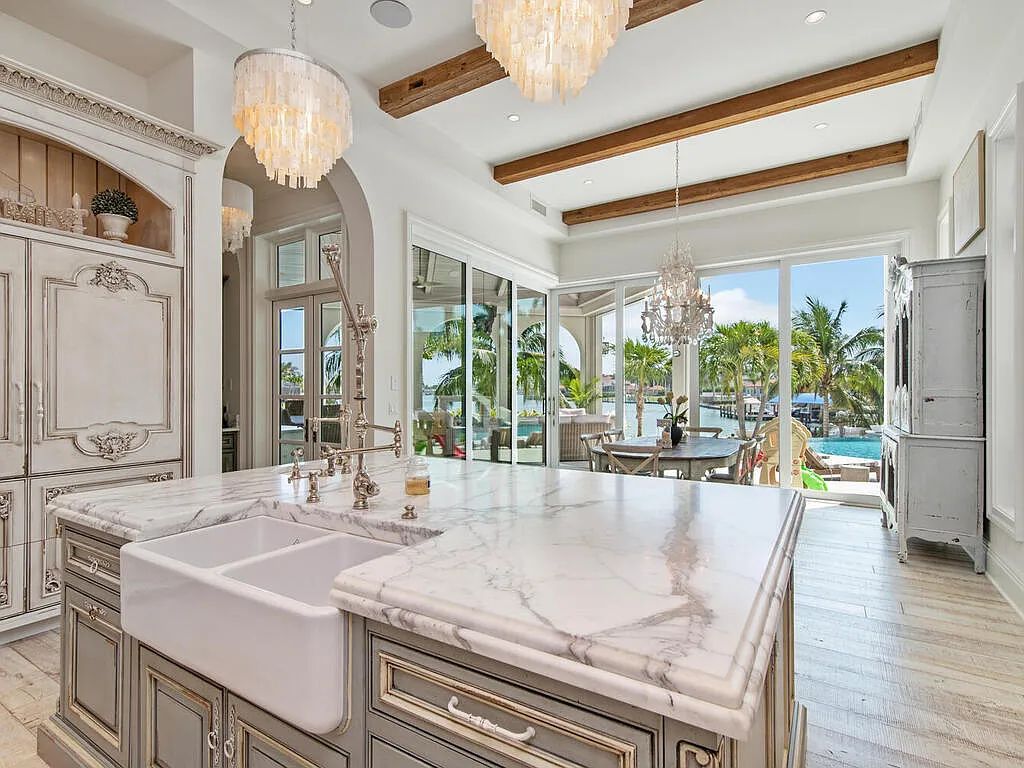 Discover your dream home at 1340 Caxambas Ct, Marco Island, Florida! This 5-bed, 5-bath luxury residence with a theater room boasts 5,007 sq ft of impeccable craftsmanship, situated on 0.59 acres with 248 ft of water frontage and a newer seawall, ensuring endless views and quick access to Caxambas Pass.