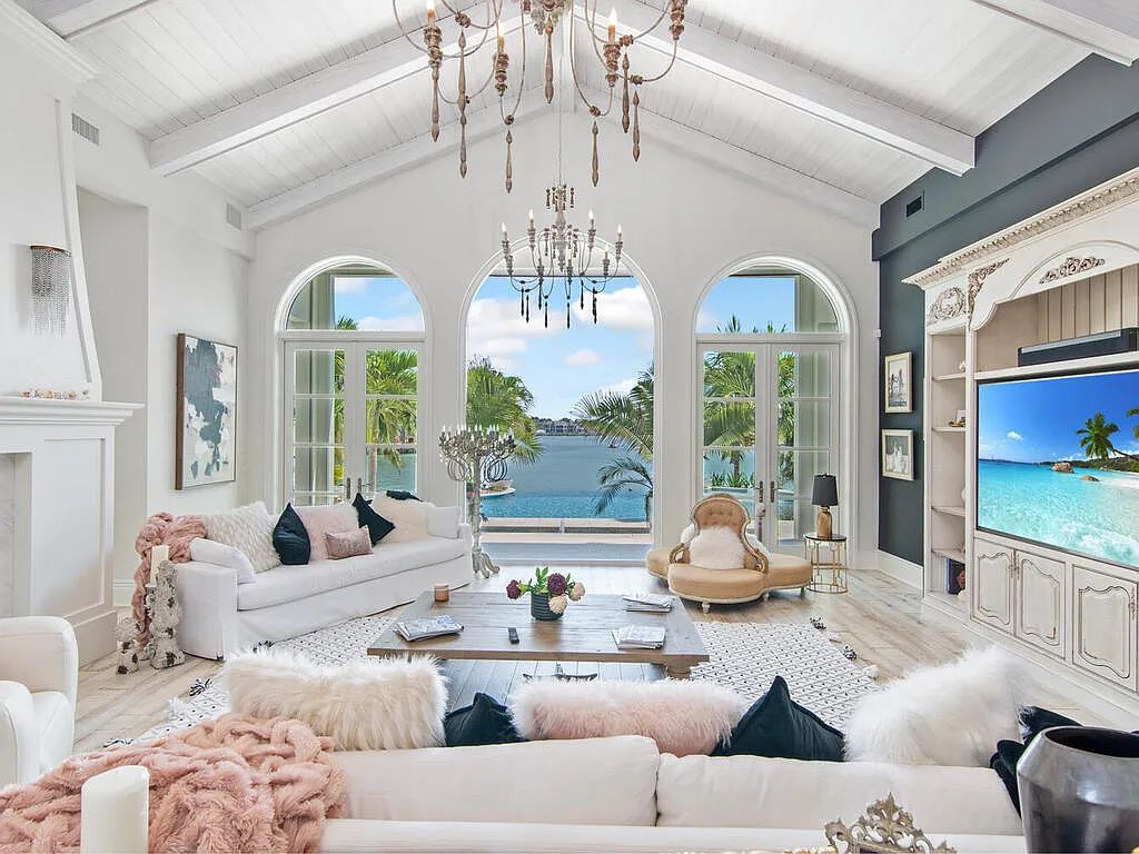 Discover your dream home at 1340 Caxambas Ct, Marco Island, Florida! This 5-bed, 5-bath luxury residence with a theater room boasts 5,007 sq ft of impeccable craftsmanship, situated on 0.59 acres with 248 ft of water frontage and a newer seawall, ensuring endless views and quick access to Caxambas Pass.