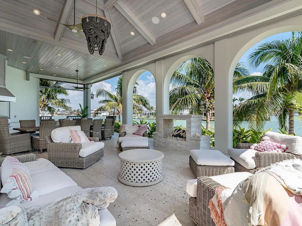Discover your dream home at 1340 Caxambas Ct, Marco Island, Florida! This 5-bed, 5-bath luxury residence with a theater room boasts 5,007 sq ft of impeccable craftsmanship, situated on 0.59 acres with 248 ft of water frontage and a newer seawall, ensuring endless views and quick access to Caxambas Pass.