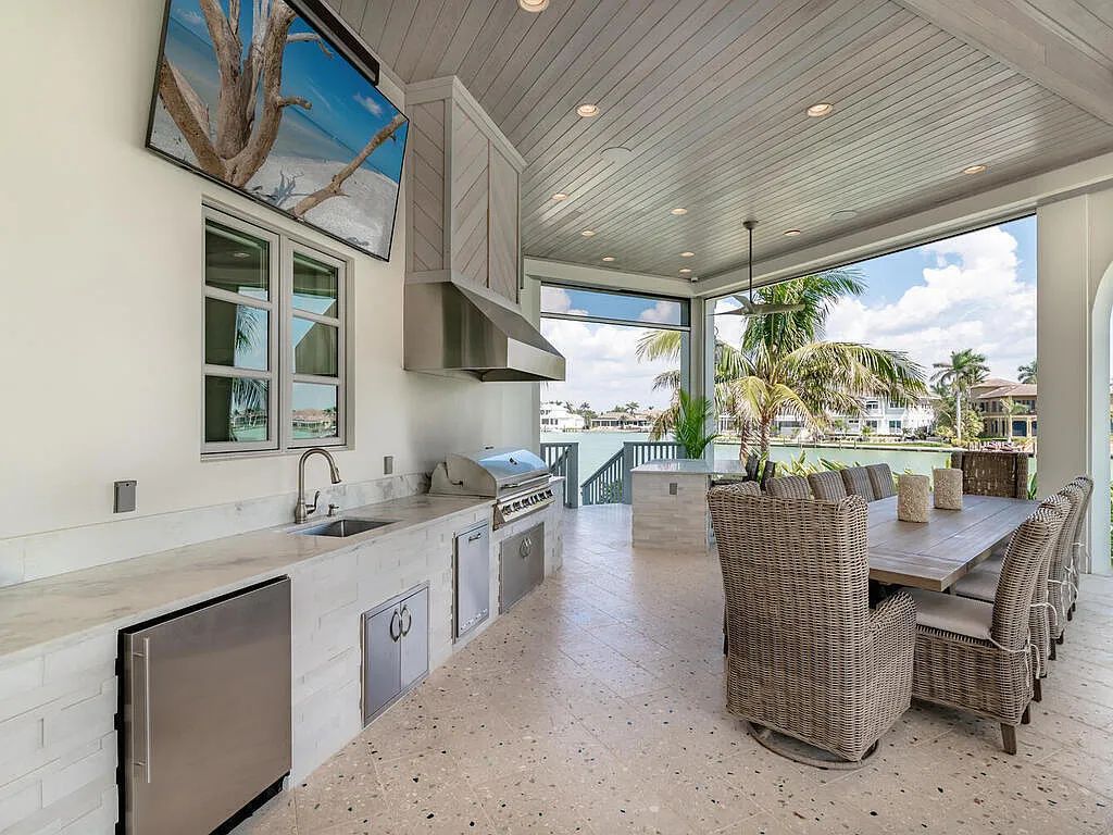 Discover your dream home at 1340 Caxambas Ct, Marco Island, Florida! This 5-bed, 5-bath luxury residence with a theater room boasts 5,007 sq ft of impeccable craftsmanship, situated on 0.59 acres with 248 ft of water frontage and a newer seawall, ensuring endless views and quick access to Caxambas Pass.