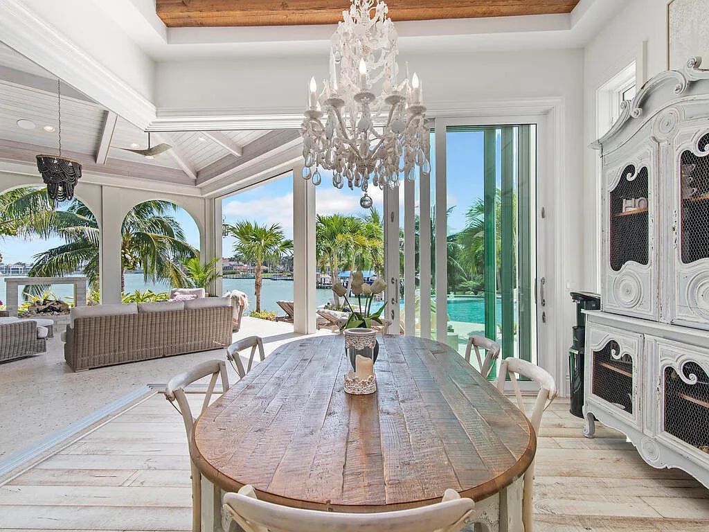 Discover your dream home at 1340 Caxambas Ct, Marco Island, Florida! This 5-bed, 5-bath luxury residence with a theater room boasts 5,007 sq ft of impeccable craftsmanship, situated on 0.59 acres with 248 ft of water frontage and a newer seawall, ensuring endless views and quick access to Caxambas Pass.