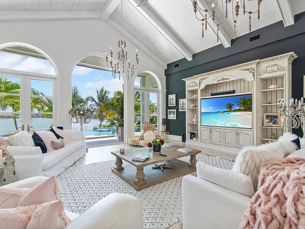 Discover your dream home at 1340 Caxambas Ct, Marco Island, Florida! This 5-bed, 5-bath luxury residence with a theater room boasts 5,007 sq ft of impeccable craftsmanship, situated on 0.59 acres with 248 ft of water frontage and a newer seawall, ensuring endless views and quick access to Caxambas Pass.