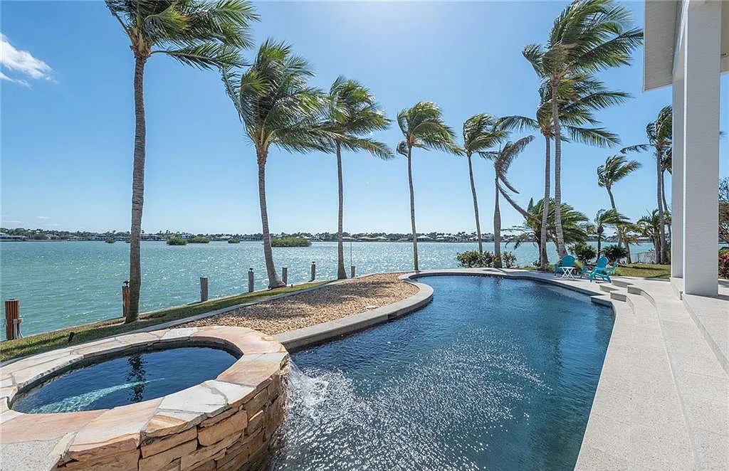 Nestled in Marco Island's prestigious Estate section, 581 Conover Ct is a waterfront gem offering 247' of direct access frontage on Roberts Bay with 11' elevation. This 2000-built Slocum & Christian home boasts an open - living concept, three bedrooms, three baths, and breathtaking water views from every room.