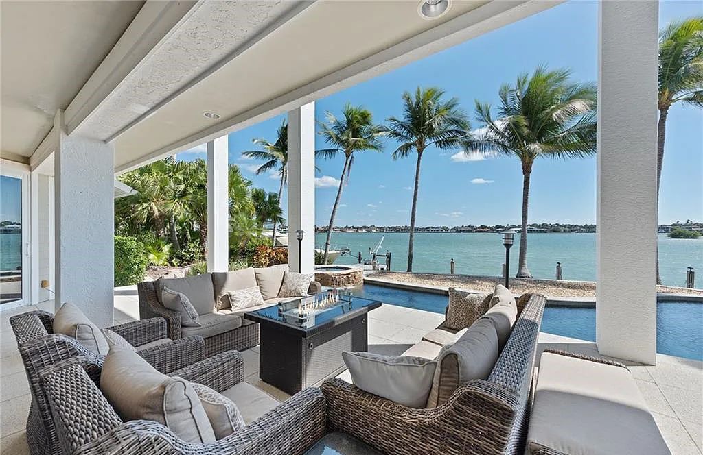 Nestled in Marco Island's prestigious Estate section, 581 Conover Ct is a waterfront gem offering 247' of direct access frontage on Roberts Bay with 11' elevation. This 2000-built Slocum & Christian home boasts an open - living concept, three bedrooms, three baths, and breathtaking water views from every room.
