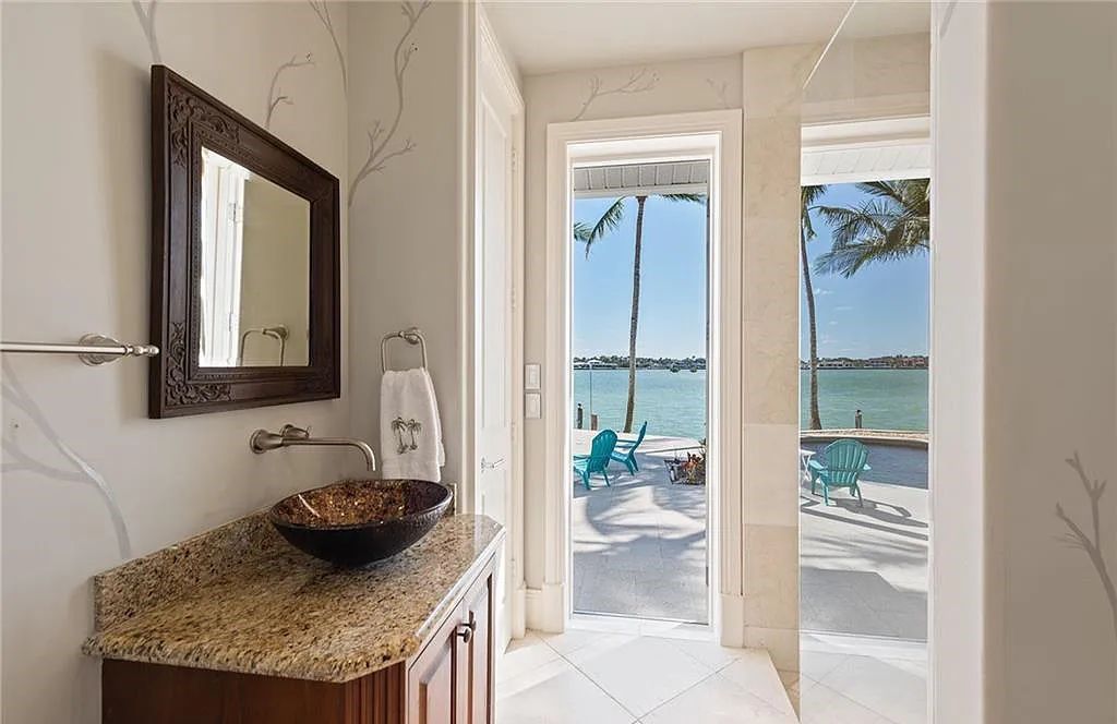 Nestled in Marco Island's prestigious Estate section, 581 Conover Ct is a waterfront gem offering 247' of direct access frontage on Roberts Bay with 11' elevation. This 2000-built Slocum & Christian home boasts an open - living concept, three bedrooms, three baths, and breathtaking water views from every room.