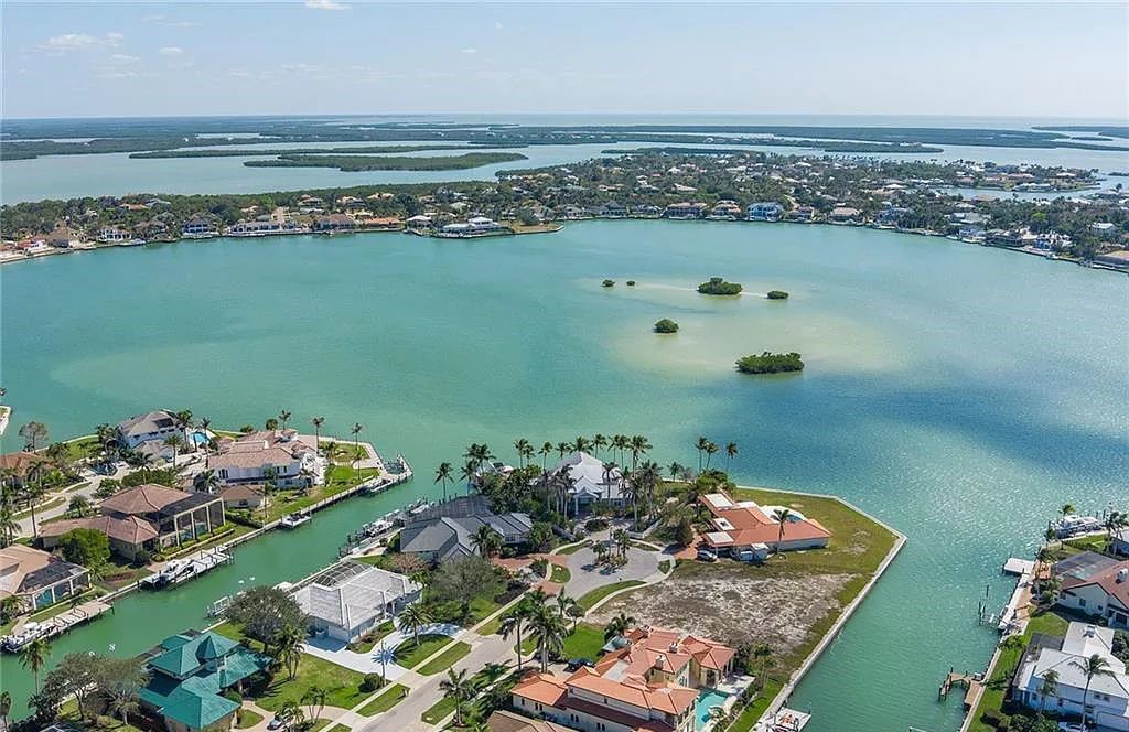 Nestled in Marco Island's prestigious Estate section, 581 Conover Ct is a waterfront gem offering 247' of direct access frontage on Roberts Bay with 11' elevation. This 2000-built Slocum & Christian home boasts an open - living concept, three bedrooms, three baths, and breathtaking water views from every room.