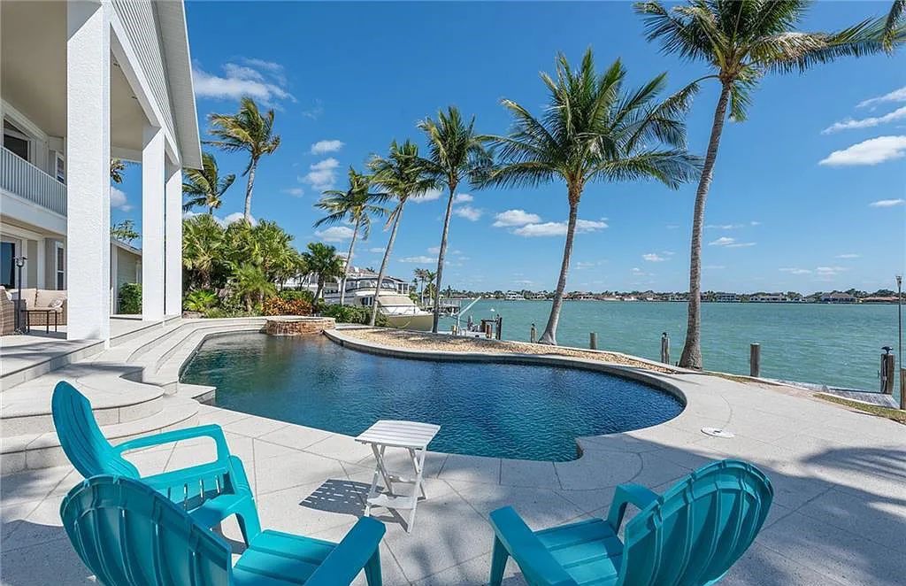 Nestled in Marco Island's prestigious Estate section, 581 Conover Ct is a waterfront gem offering 247' of direct access frontage on Roberts Bay with 11' elevation. This 2000-built Slocum & Christian home boasts an open - living concept, three bedrooms, three baths, and breathtaking water views from every room.