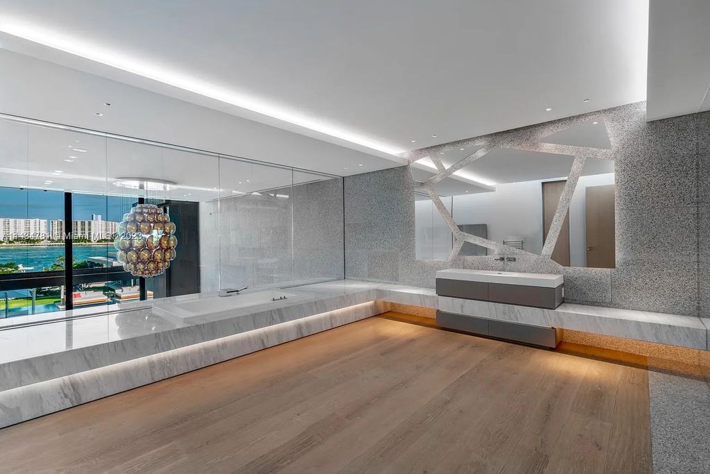 Nestled on the exclusive Star Island in Miami Beach, this 2019-built estate at 27 Star Island Drive is the epitome of luxury living. With 9 bedrooms and 12 bathrooms, the meticulously crafted interiors span nearly 23,000 square feet, showcasing a breathtaking 21-foot-high ceiling salon, a chef's dream kitchen, and multiple entertainment spaces, including two media rooms.