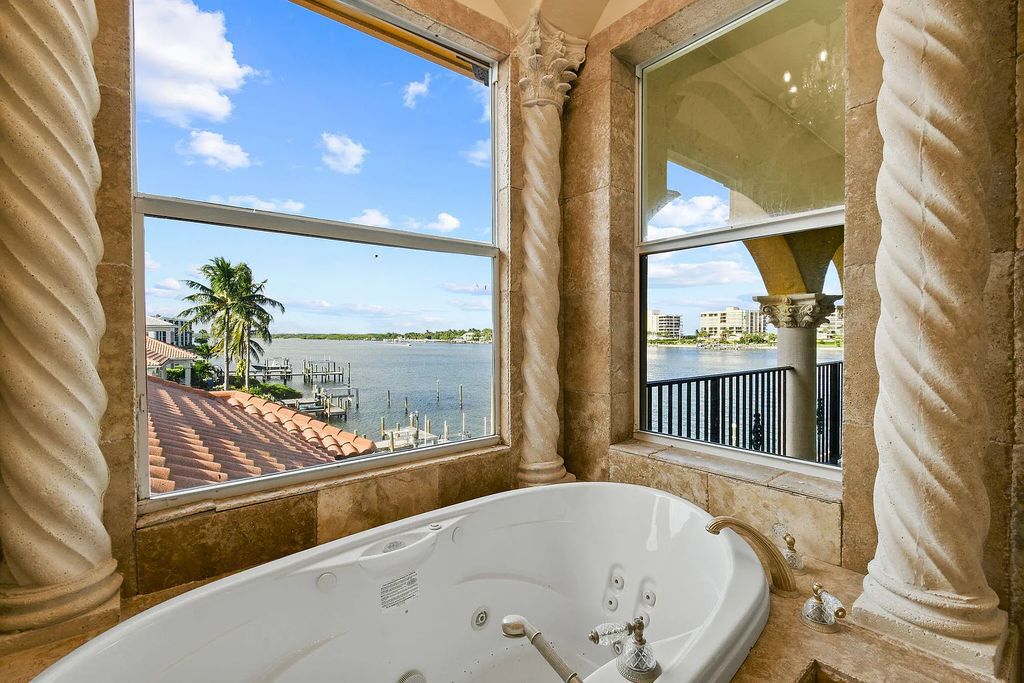 Discover unparalleled waterfront living at 19709 Harbor Road, Jupiter, Florida. This exquisite 3-bedroom, 4-bathroom estate, spanning 5,319 square feet on a 0.37-acre lot, presents breathtaking Intracoastal Waterway views.