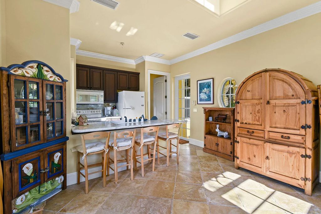 Discover unparalleled waterfront living at 19709 Harbor Road, Jupiter, Florida. This exquisite 3-bedroom, 4-bathroom estate, spanning 5,319 square feet on a 0.37-acre lot, presents breathtaking Intracoastal Waterway views.