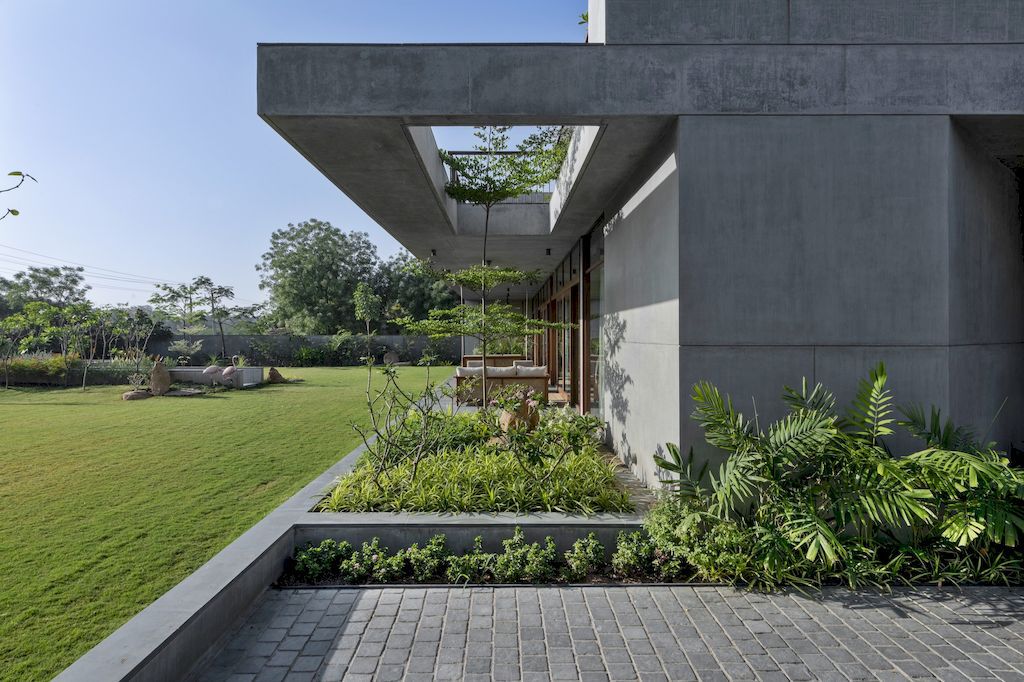The Monolithic House Features Open & Green Spaces by MODO Designs