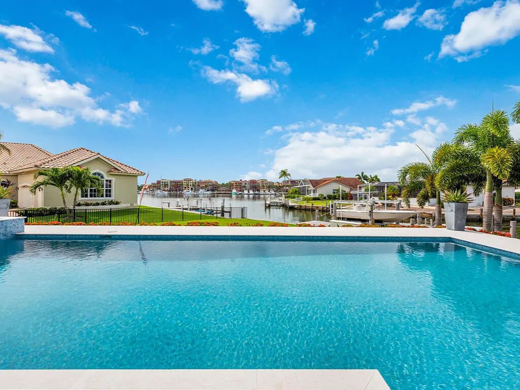 Discover waterfront perfection at 681 Crescent St, Marco Island, FL. This 2020-built, lightly lived-in masterpiece offers 4 bedrooms, 5 baths, and 4,047 square feet of luxury living. Its open split floor plan seamlessly blends indoor and outdoor spaces, revealing breathtaking bay views.