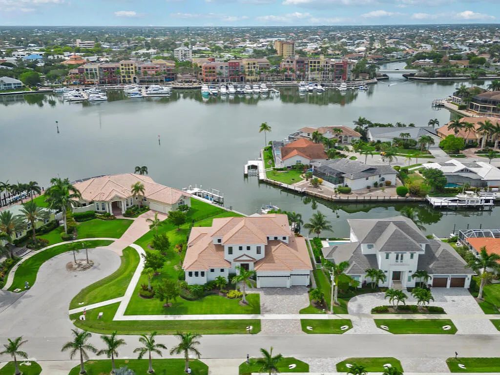 Discover waterfront perfection at 681 Crescent St, Marco Island, FL. This 2020-built, lightly lived-in masterpiece offers 4 bedrooms, 5 baths, and 4,047 square feet of luxury living. Its open split floor plan seamlessly blends indoor and outdoor spaces, revealing breathtaking bay views.