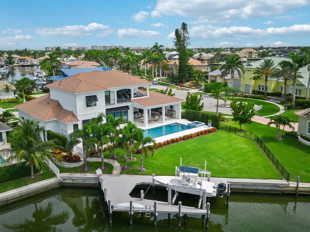 Discover waterfront perfection at 681 Crescent St, Marco Island, FL. This 2020-built, lightly lived-in masterpiece offers 4 bedrooms, 5 baths, and 4,047 square feet of luxury living. Its open split floor plan seamlessly blends indoor and outdoor spaces, revealing breathtaking bay views.