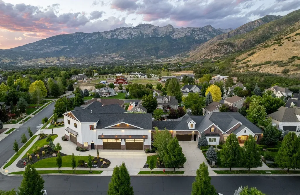 1263 East Chapman Court Home in Alpine, Utah. Step into the lap of luxury in this expansive 13,000 sq ft home in Alpine, Utah. With 8 oversized bedrooms, 6 bathrooms, a 13-car garage, and an outdoor entertainment paradise featuring a pool, spa, and lush landscaping, this property is perfect for hosting and living in grand style.
