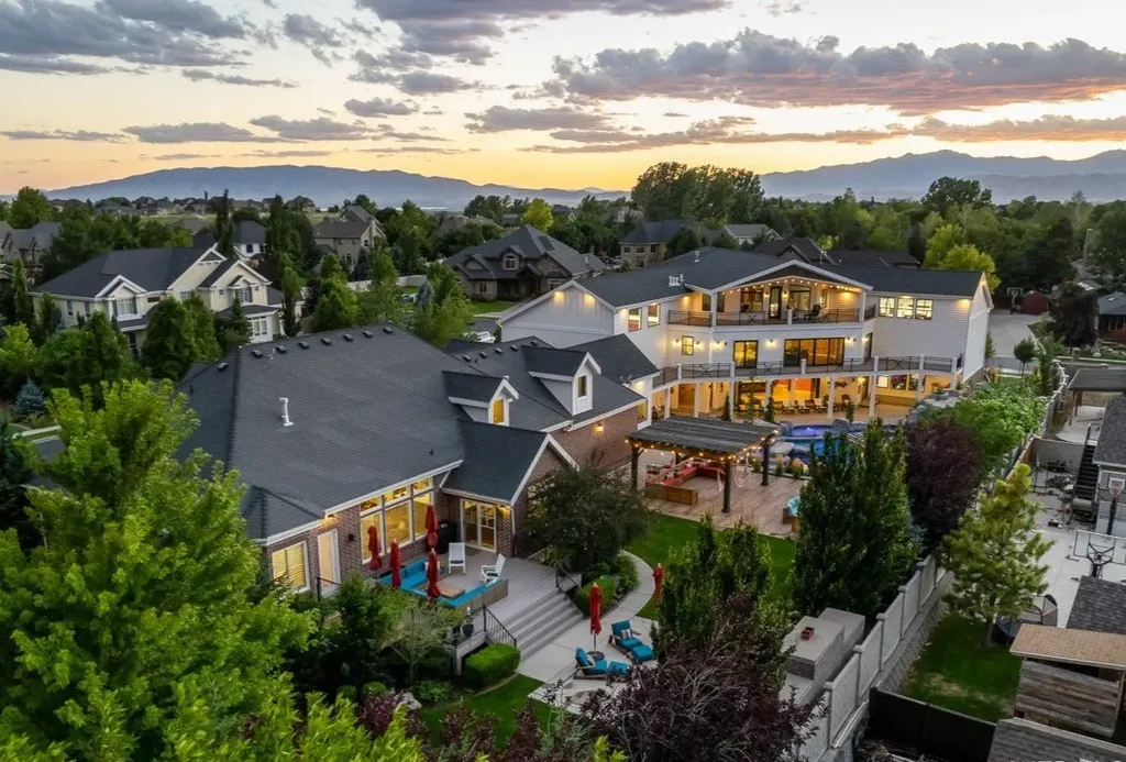 1263 East Chapman Court Home in Alpine, Utah. Step into the lap of luxury in this expansive 13,000 sq ft home in Alpine, Utah. With 8 oversized bedrooms, 6 bathrooms, a 13-car garage, and an outdoor entertainment paradise featuring a pool, spa, and lush landscaping, this property is perfect for hosting and living in grand style.