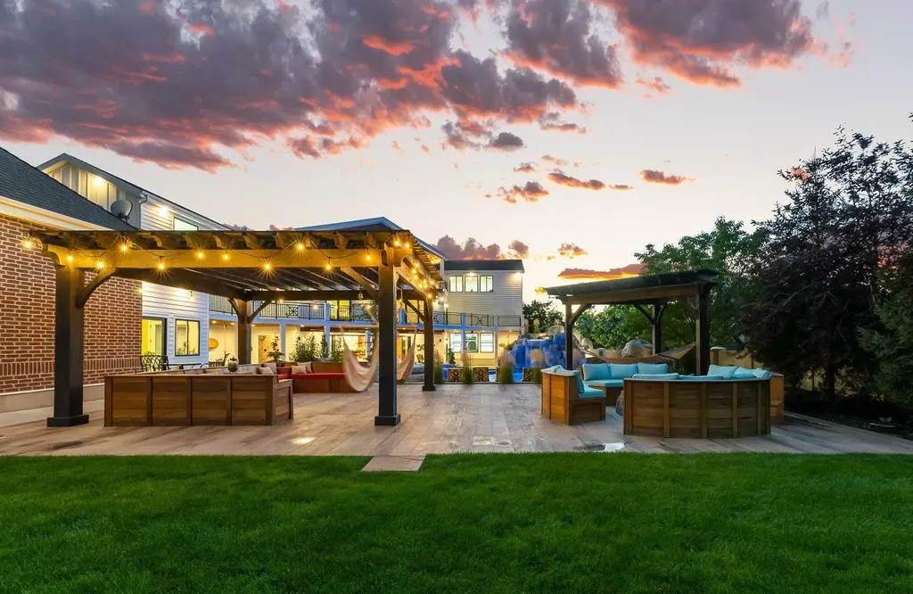 1263 East Chapman Court Home in Alpine, Utah. Step into the lap of luxury in this expansive 13,000 sq ft home in Alpine, Utah. With 8 oversized bedrooms, 6 bathrooms, a 13-car garage, and an outdoor entertainment paradise featuring a pool, spa, and lush landscaping, this property is perfect for hosting and living in grand style.