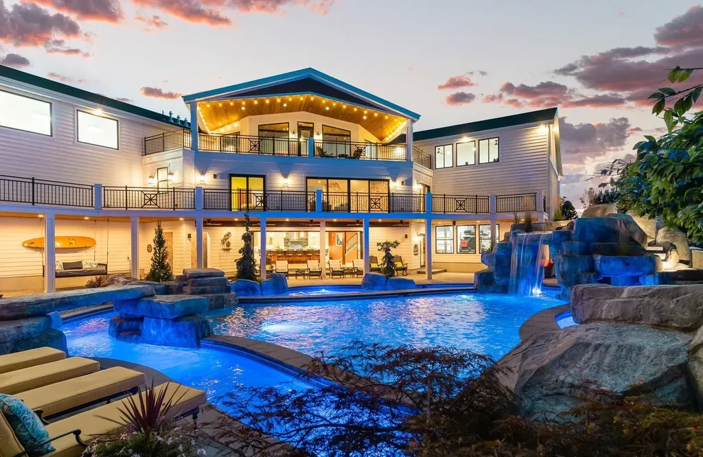 1263 East Chapman Court Home in Alpine, Utah. Step into the lap of luxury in this expansive 13,000 sq ft home in Alpine, Utah. With 8 oversized bedrooms, 6 bathrooms, a 13-car garage, and an outdoor entertainment paradise featuring a pool, spa, and lush landscaping, this property is perfect for hosting and living in grand style.